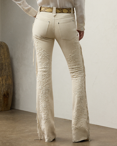The Annabeth unites Western-inspired style with modern luxury. Crafted in Italy with sumptuous calf suede that's specially treated with hand-applied, neutral-tone wax for a vintage appearance, these bootcut trousers are detailed with strips of calf suede along the side seams to create fringe trim characteristic of vintage Western fashion. Traditional jean elements, including a signature buttoned closure, metal rivets and a mid-rise fit, lend a sense of casual ease to this refined style, while intricate floral embroidery affords romantic intrigue.