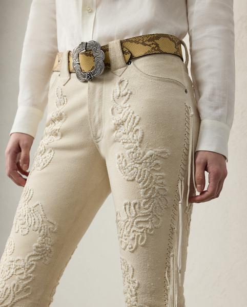 The Annabeth unites Western-inspired style with modern luxury. Crafted in Italy with sumptuous calf suede that's specially treated with hand-applied, neutral-tone wax for a vintage appearance, these bootcut trousers are detailed with strips of calf suede along the side seams to create fringe trim characteristic of vintage Western fashion. Traditional jean elements, including a signature buttoned closure, metal rivets and a mid-rise fit, lend a sense of casual ease to this refined style, while intricate floral embroidery affords romantic intrigue.