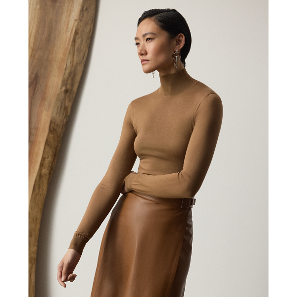 A timeless wardrobe staple,  Ralph Lauren Lauren Collection puts a luxurious spin on the mockneck jumper with a stretch-infused silk jersey fabrication and a slim fit.