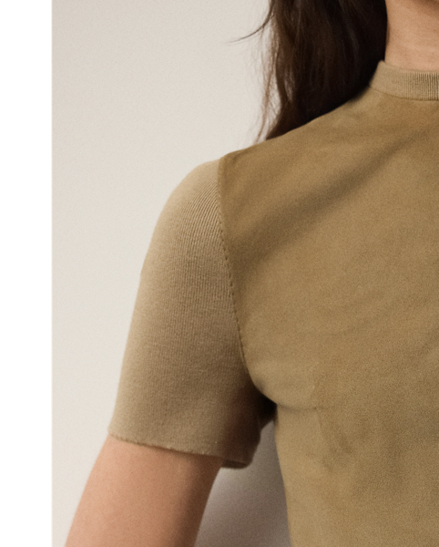 A hybrid of luxurious materials, the season's Lindsay dress unites two one-of-a-kind fabrics to create its clean sheath silhouette. For the crewneck, sleeves and back, a rib-knit wool-and-silk blend is used, while sumptuous lamb-suede panels with edge-stitching details grace the front. This timeless style comes with a self-belt centred by a signature " Ralph Lauren Lauren"-engraved metal buckle.