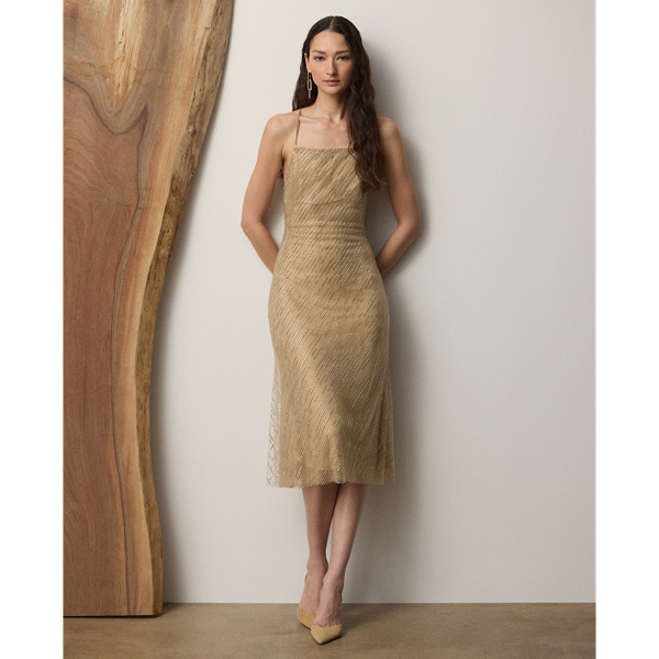  Ralph Lauren Lauren has been forever known as a fashion house dedicated to creating designs that are both modern and timeless, which is brought to life here in the season's Donnely. A study in fine Italian crafting, the Donnely's '90s-inspired slip silhouette is composed of two refined layers, including a delicate mesh fabric with hot-fixed crystals for the underlayer and lightweight tulle with hand-applied, bias-placed crystals for the exterior, forming a dress that shimmers effortlessly with each step. Tonal, crystal-embellished shoulder straps crisscross at the back for a dramatic finishing touch.