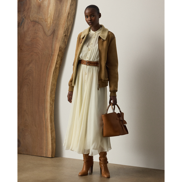 Epitomising Mr Lauren's penchant for romanticising menswear dress codes, this version of the shirtdress – one of Ralph Lauren Lauren's signature silhouettes – is designed with an array of highly considered elements, including delicate shirring throughout, billowing blouson sleeves and ruffle trim along the band collar. Effortlessly elegant, the Grantly is crafted in Italy from 100% silk chiffon woven with a crinkle texture, providing depth and dimension while remaining sheer and breezy. Additional details, including side on-seam pockets and a belted waist, showcase Ralph Lauren Lauren's attention to the finer details of womenswear.