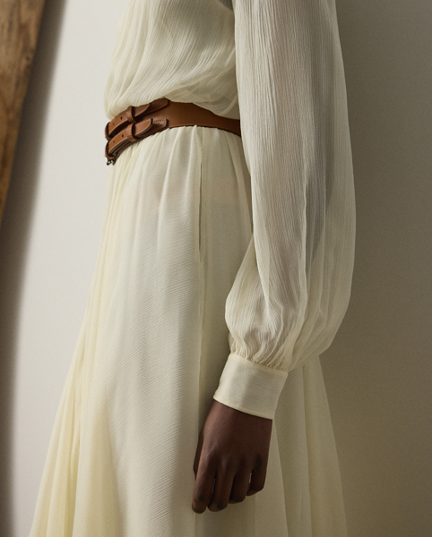 Epitomising Mr Lauren's penchant for romanticising menswear dress codes, this version of the shirtdress – one of Ralph Lauren Lauren's signature silhouettes – is designed with an array of highly considered elements, including delicate shirring throughout, billowing blouson sleeves and ruffle trim along the band collar. Effortlessly elegant, the Grantly is crafted in Italy from 100% silk chiffon woven with a crinkle texture, providing depth and dimension while remaining sheer and breezy. Additional details, including side on-seam pockets and a belted waist, showcase Ralph Lauren Lauren's attention to the finer details of womenswear.