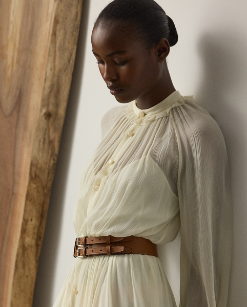 Epitomising Mr Lauren's penchant for romanticising menswear dress codes, this version of the shirtdress – one of Ralph Lauren Lauren's signature silhouettes – is designed with an array of highly considered elements, including delicate shirring throughout, billowing blouson sleeves and ruffle trim along the band collar. Effortlessly elegant, the Grantly is crafted in Italy from 100% silk chiffon woven with a crinkle texture, providing depth and dimension while remaining sheer and breezy. Additional details, including side on-seam pockets and a belted waist, showcase Ralph Lauren Lauren's attention to the finer details of womenswear.