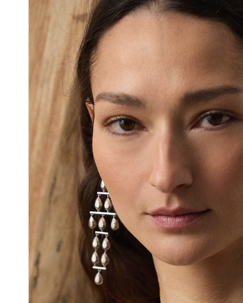 Inspired by  Ralph Lauren Lauren's iconic Chilton dress, the Corra showcases Mr Lauren's ability to transform timeless silhouettes into modern designs. Crafted in Italy with full-bodied stretch satin for a fluid drape and perfect sheen, this evening gown is distinguished by a halter neckline that easily secures with a metal lobster-clasp closure. Its figure-skimming column silhouette features crisp pleating at the neckline and a centre back skirt slit for ease of movement.