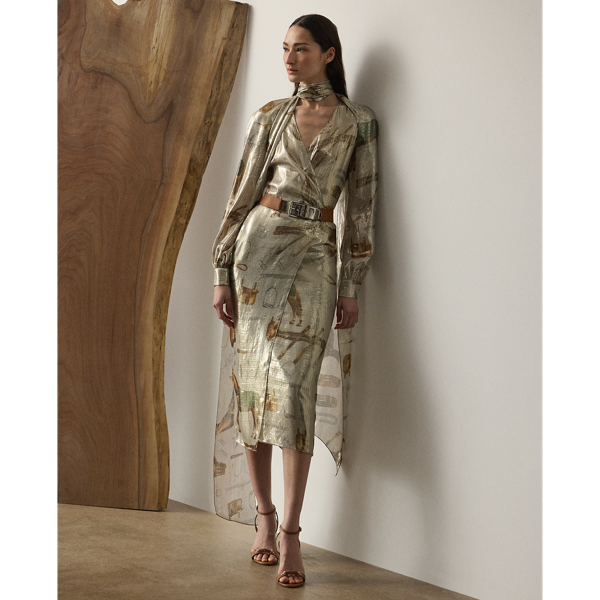 The Terry cocktail dress nods to traditional riding attire – an enduring source of inspiration for Mr Lauren since his earliest designs. Crafted from shimmering, silver-tone lamé fabric, this lean wrap dress is printed with the season's all-over equestrian-inspired motif in a renowned Italian mill in Como and designed with an array of romantic elements, including an engineered scarf, blouson sleeves and genuine mother-of-pearl buttons.