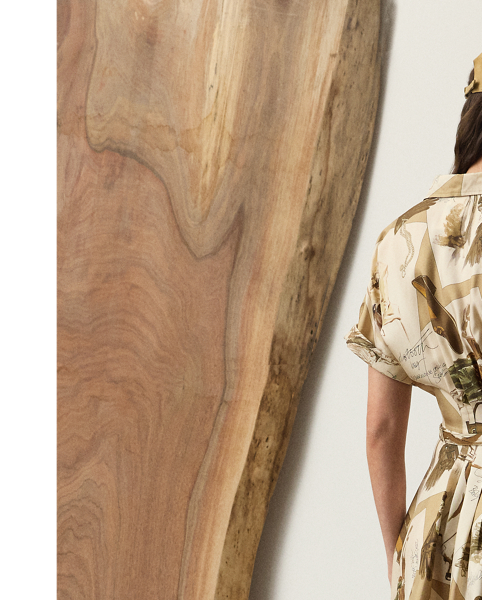 The shirtdress – one of  Ralph Lauren Lauren's most iconic silhouettes – is reinterpreted for Pre-Autumn 2025 as the Donatella day dress. Crafted with silk twill, this style is printed in a renowned Como, Italy, mill with the season's diary-inspired pattern – a beautiful collection of motifs depicting various  Ralph Lauren Lauren sketches and accessories in a versatile, neutral palette. Additional touches, including rolled dolman sleeves, side on-seam pockets and a buckled self-belt, lend to its casual sensibility, while a French placket and calf-grazing silhouette nod to the enduring elegance that defines the house.