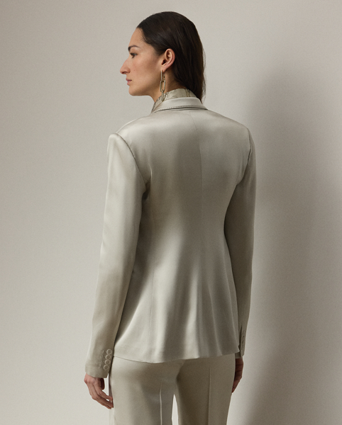 Equestrian-style hacking pockets and genuine mother-of-pearl buttons accent this season's version of the Parker jacket, which is crafted with full-bodied stretch satin for a fluid drape and perfect sheen. Traditional men's tailoring techniques ensure it maintains its slim, waist-defining silhouette for years to come.