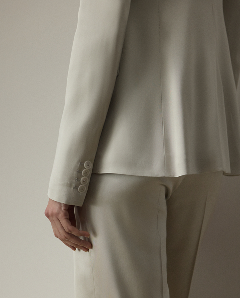 Equestrian-style hacking pockets and genuine mother-of-pearl buttons accent this season's version of the Parker jacket, which is crafted with full-bodied stretch satin for a fluid drape and perfect sheen. Traditional men's tailoring techniques ensure it maintains its slim, waist-defining silhouette for years to come.