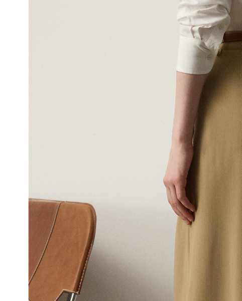 Tailored with pleats, waist darts and crisp creases down each leg, the high-rise Jody trouser is woven with Italian wool trench in a compact weave specially selected for its structured form and stunning drape.