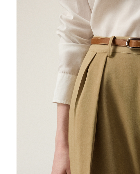 Tailored with pleats, waist darts and crisp creases down each leg, the high-rise Jody trouser is woven with Italian wool trench in a compact weave specially selected for its structured form and stunning drape.
