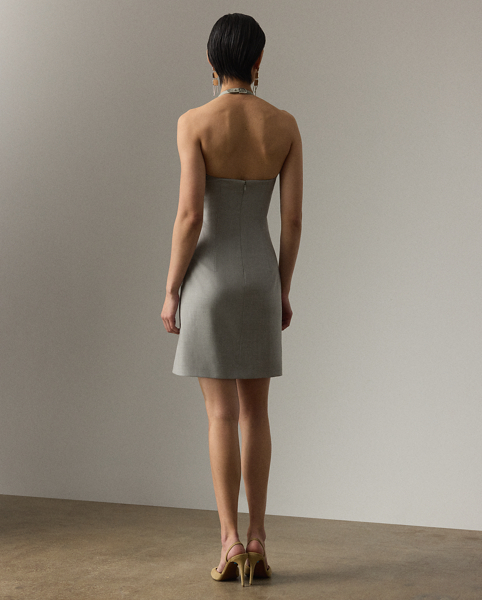 Uniting traditional tailoring with a sporty sensibility, the Kymberly's '90s-inspired mini silhouette features sleek side panels and a halter neckline, which secures with a lamb-suede latch and Ralph Lauren Lauren's iconic stirrup buckle. This sleeveless day dress is crafted with extra-fine worsted wool, selected especially for its brushed, lofty finish and remarkable drape.