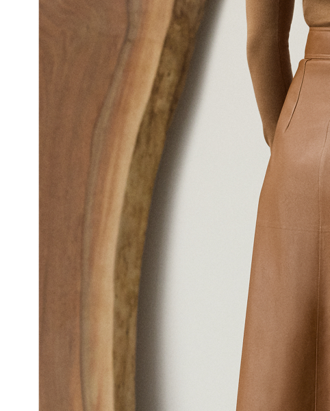 Evoking the sleek, clean aesthetic that defines Pre-Autumn 2025 Collection, the Jackeline midi skirt is cut for a subtle A-line silhouette that hits just below the knee. Designed with a wrap closure that easily secures with an engineered buckled waistband and an interior snapped closure, this timeless style is crafted in Italy from supple nappa lambskin that's specially dyed and finished to achieve its rich coloring.