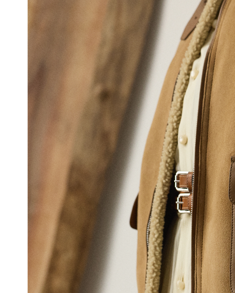 Inspired by traditional flight jackets, the Morrison coat is crafted from a luxurious combination of textures, including soft, ultra-lightweight wool shearling, which displays a semi-curly interior and a smooth suede exterior, and supple lambskin taping for a sophisticated yet dynamic contrast, which enhances the relaxed-fitting design of this coat. Additional details, including a lambskin buckled throatlatch, rib-knit cuffs and hem, and lambskin flapped pockets, complete the look.