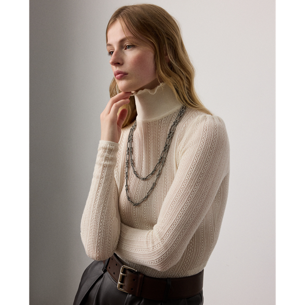 Inspired by the elaborate, ornate detailing that defines Victorian-era fashion, this roll neck jumper is spun with incredibly lightweight silk and cashmere yarns in a delicate lace and pointelle stitch layout. Ruffled edges at the neckline and puffed sleeve caps elevate its romantic design.