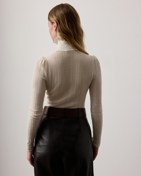 Inspired by the elaborate, ornate detailing that defines Victorian-era fashion, this roll neck jumper is spun with incredibly lightweight silk and cashmere yarns in a delicate lace and pointelle stitch layout. Ruffled edges at the neckline and puffed sleeve caps elevate its romantic design.