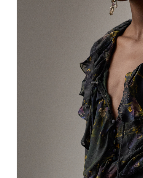 The Carol jumpsuit embodies the modern, romantic aesthetic that defines Autumn 2025 Collection. Featuring Victorian-inspired design elements, including ruffles along the neckline and at the sleeve cuffs, this straight-leg jumpsuit is crafted in Italy from a special satin fabrication printed with the season's lilac motif, which was first hand-painted in-house by  Ralph Lauren Lauren artists, then reproduced as a print in a renowned Como, Italy, mill. To achieve the fabric's watercolour effect, this style undergoes two different printing techniques: first traditionally printed, then with a devoré technique, which dissolves the viscose yarns to leave a slightly transparent silk base. Adjustable self-ties create a versatile neckline that can be styled open or closed, allowing you to switch up your look with ease.