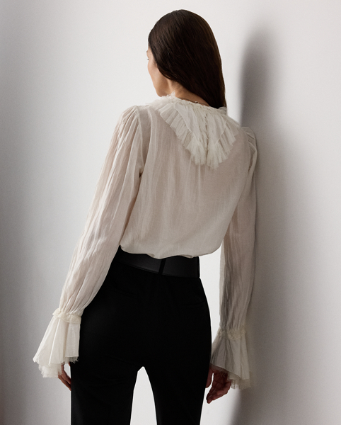 Evoking the ornate beauty that defines Victorian-era fashion, the Kensley blouse is crafted with ultrafine cotton-and-silk voile for a soft hand feel and a semi-sheer effect. With playful tulle ruffles at the neckline and cuffs, this airy top is embroidered with Ralph Lauren Lauren's script monogram at the collar points.