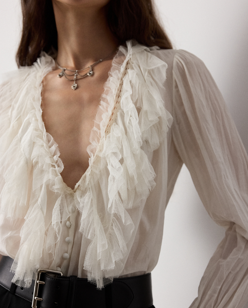 Evoking the ornate beauty that defines Victorian-era fashion, the Kensley blouse is crafted with ultrafine cotton-and-silk voile for a soft hand feel and a semi-sheer effect. With playful tulle ruffles at the neckline and cuffs, this airy top is embroidered with Ralph Lauren Lauren's script monogram at the collar points.