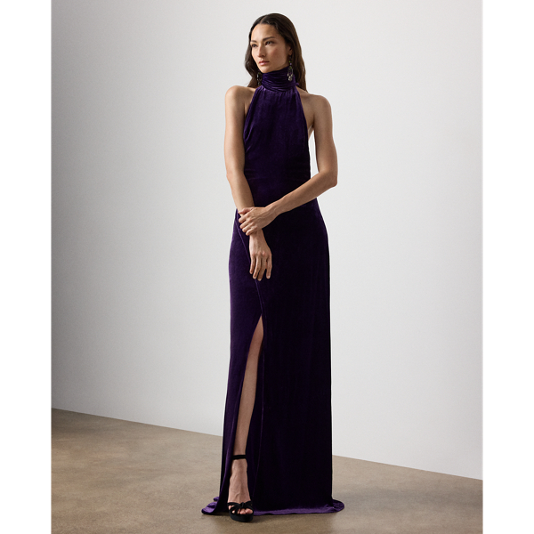 Inspired by Ralph Lauren Lauren's iconic Chilton dress, the Tatum showcases Mr Lauren's ability to transform timeless silhouettes into modern designs. Crafted in Italy from lightweight, comfort stretch velvet for a remarkable drape and beautiful sheen, this evening gown is distinguished by a halter neckline with a dramatic scarf that cascades gracefully down the body. Its figure-skimming column silhouette features an engineered skirt slit that starts at the back, then wraps around to the front for ease of movement.