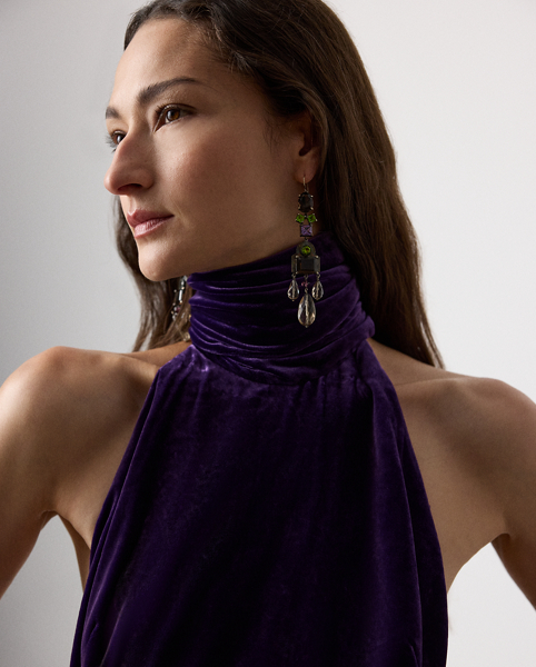 Inspired by Ralph Lauren Lauren's iconic Chilton dress, the Tatum showcases Mr Lauren's ability to transform timeless silhouettes into modern designs. Crafted in Italy from lightweight, comfort stretch velvet for a remarkable drape and beautiful sheen, this evening gown is distinguished by a halter neckline with a dramatic scarf that cascades gracefully down the body. Its figure-skimming column silhouette features an engineered skirt slit that starts at the back, then wraps around to the front for ease of movement.