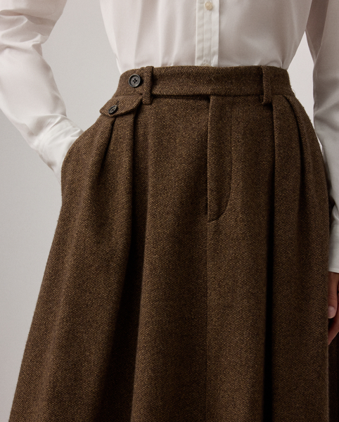 An elevated wardrobe staple, the Evilyn reimagines the timeless A-line skirt with trouser-inspired elements, including belt loops, a zip fly with a buttoned waist tab, and a coin pocket. Tailored with front waist pleats and back waist darts, this skirt is crafted from neutral, yard-dyed Italian tweed – a fabric custom-developed with soft wool yarns woven in a birdseye structure to create a light, jumper-like hand feel.