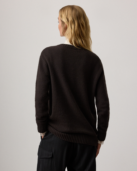 For Autumn 2025, Mr Lauren was inspired by the intricate beauty of Victorian-era designs, which is evident in the season's Autumn Polo Bear cashmere jumper. Four specialised technicians created the Polo Bear patch using a mix of embroidery techniques and a collection of highly considered materials, including a rich wool blend for the coat, soft cotton-and-silk voile for the blouse, wool flannel for the trousers, faux leather for the shoes and belt and dry-cleanable lambskin for the Ricky bag. Additional details, including embroidered neck lace and a special thread technique for the pinstripes and rodeo buckle, nod to the season's focus on the finer details.