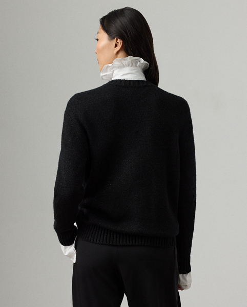 For Holiday 2025, Mr Lauren was inspired by the intricate beauty of Victorian-era designs, which is evident in the season's Holiday Polo Bear jumper. Spun with our lofty cashmere and a hint of metallic yarn for a subtle sheen, four specialised technicians created the Polo Bear patch using a mix of embroidery techniques and a collection of highly considered materials, including lightweight velvet for the trousers and waistcoat, cotton broadcloth for the shirt and faux leather for the jacket and shoes. Additional details, including a three-dimensional shirt collar, an embroidered pocket watch and brooch and hot-fixed rhinestones for the diamond earrings, nod to the season's focus on the finer details.