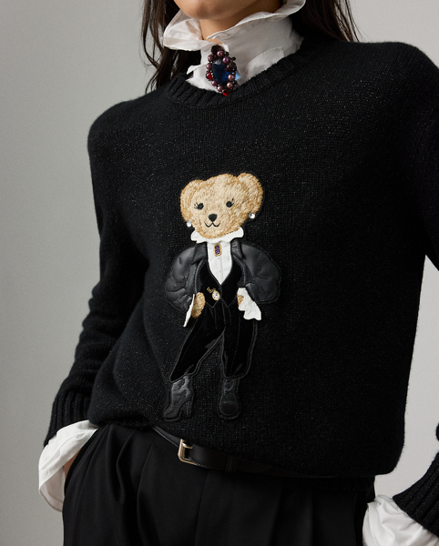 For Holiday 2025, Mr Lauren was inspired by the intricate beauty of Victorian-era designs, which is evident in the season's Holiday Polo Bear jumper. Spun with our lofty cashmere and a hint of metallic yarn for a subtle sheen, four specialised technicians created the Polo Bear patch using a mix of embroidery techniques and a collection of highly considered materials, including lightweight velvet for the trousers and waistcoat, cotton broadcloth for the shirt and faux leather for the jacket and shoes. Additional details, including a three-dimensional shirt collar, an embroidered pocket watch and brooch and hot-fixed rhinestones for the diamond earrings, nod to the season's focus on the finer details.