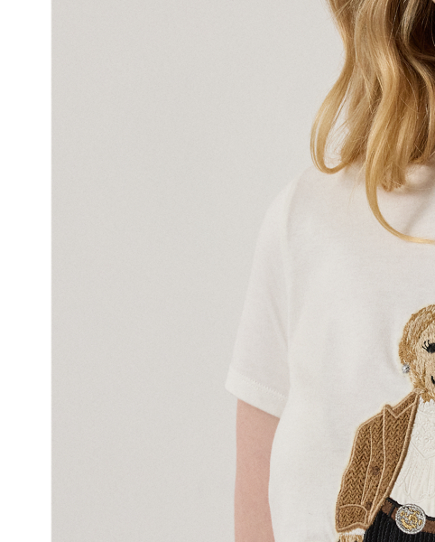 For Autumn 2025, Mr Lauren was inspired by the intricate beauty of Victorian-era designs, which is evident in the season's Autumn Polo Bear tee. Four specialised technicians created the Polo Bear patch using a mix of embroidery techniques and a collection of highly considered materials, including a rich wool blend for the coat, soft cotton-and-silk voile for the blouse, wool flannel for the trousers and dry-cleanable lambskin for the Ricky bag. Additional details, including embroidered neck lace and a special thread technique for the pinstripes and rodeo buckle, nod to the season's focus on the finer details. This T-shirt is crafted with cotton jersey and finished with " Ralph Lauren Lauren" script embroidery.