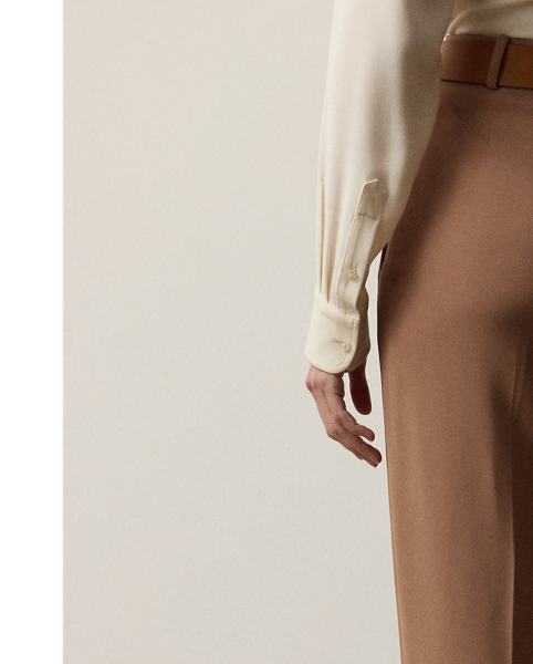 The Gillian trouser is crafted in Italy from a soft, delicate cady fabrication, for which highly twisted crepe yarns are woven with moderate stretch, resulting in a supple, fluid drape and a lightweight feel. Crisp creases and genuine horn buttons adorn these timeless trousers, which are designed with buttoned tabs on the hems for a more tapered fit.