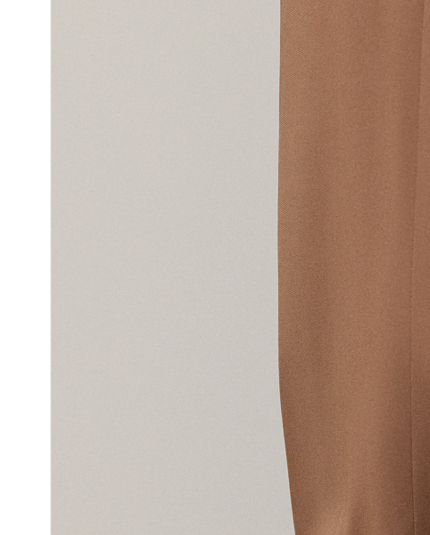 The Gillian trouser is crafted in Italy from a soft, delicate cady fabrication, for which highly twisted crepe yarns are woven with moderate stretch, resulting in a supple, fluid drape and a lightweight feel. Crisp creases and genuine horn buttons adorn these timeless trousers, which are designed with buttoned tabs on the hems for a more tapered fit.