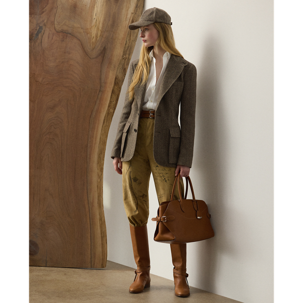 The Gillian trouser is crafted in Italy from sumptuous lamb suede, which is specially printed with one of the season's equestrian-inspired motifs – a soft, understated pattern depicting horses, riding equipment and hints of paisley. Crisp creases and genuine horn buttons adorn these timeless trousers, which are designed with buttoned tabs on the hems for a more tapered fit.