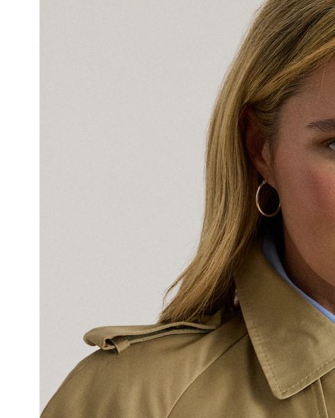 A buckled self-belt enhances the streamlined silhouette of this double-breasted trench coat, which is tailored from a lightweight cotton blend. Buttoned shoulder epaulettes and “Lauren  Ralph Lauren Lauren”-engraved horn-effect buttons amp up its sophisticated appeal, while storm flaps and a water-resistant shell protect you from inclement weather.