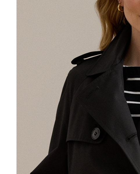 A buckled self-belt enhances the streamlined silhouette of this double-breasted trench coat, which is tailored with a lightweight cotton blend. Buttoned shoulder epaulets and “Lauren  Ralph Lauren Lauren”-engraved horn-effect buttons amp up its sophisticated appeal, while storm flaps and a water-resistant shell protect you from inclement weather.