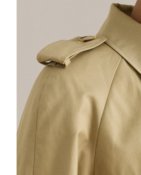 A buckled self-belt enhances the streamlined silhouette of this double-breasted trench coat, which is tailored with a lightweight cotton blend. Buttoned shoulder epaulets and “Lauren  Ralph Lauren Lauren”-engraved horn-effect buttons amp up its sophisticated appeal, while storm flaps and a water-resistant shell protect you from inclement weather.