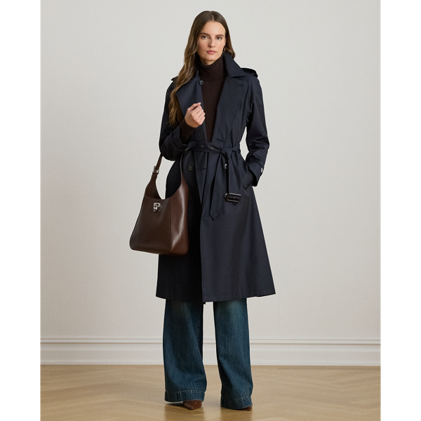 A buckled self-belt enhances the streamlined silhouette of this double-breasted trench coat, which is tailored with a lightweight cotton blend. Buttoned shoulder epaulets and “Lauren  Ralph Lauren Lauren”-engraved horn-effect buttons amp up its sophisticated appeal, while storm flaps and a water-resistant shell protect you from inclement weather.