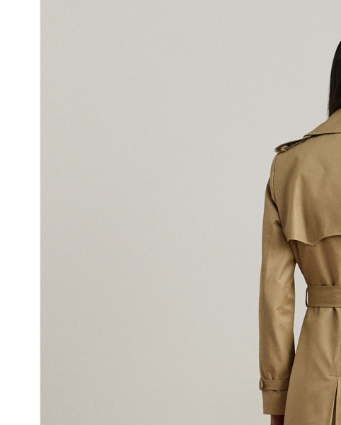 Rendered in a soft cotton blend, Lauren's take on the trench coat showcases traditional styling details, including a double-breasted silhouette and buttoned shoulder epaulets. A buckled self-belt accentuates the waist, while "Lauren  Ralph Lauren Lauren"-engraved horn-effect buttons lend a signature finish.