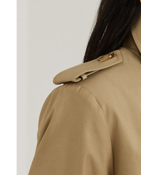 Rendered in a soft cotton blend, Lauren's take on the trench coat showcases traditional styling details, including a double-breasted silhouette and buttoned shoulder epaulets. A buckled self-belt accentuates the waist, while "Lauren  Ralph Lauren Lauren"-engraved horn-effect buttons lend a signature finish.