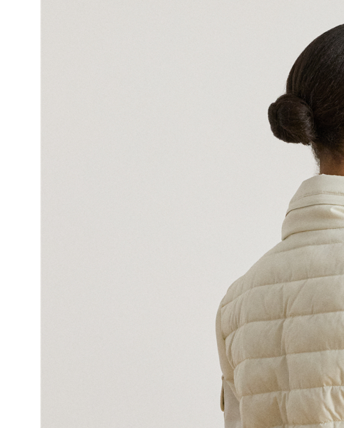 Designed with a stowaway hood that tucks into its funnelneck, this versatile puffer jacket features an insulated channel-quilted construction and a drawcord waist for the perfect cosy fit.