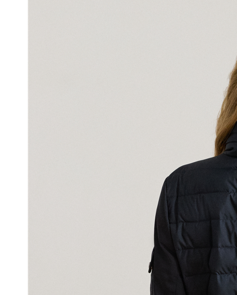 Designed with a stowaway hood that tucks into its funnelneck, this versatile puffer jacket features an insulated channel-quilted construction and a drawcord waist for the perfect cosy fit.