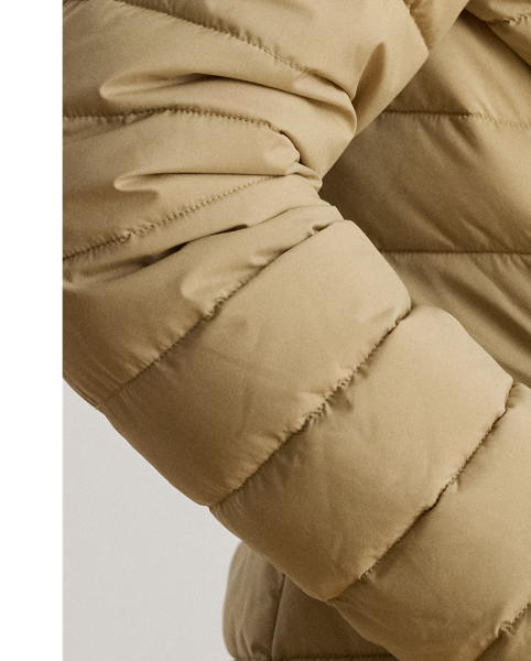 Designed with a drawcord hood and an insulated silhouette to keep you warm, this style features a channel-quilted puffer shell layered over a vestee. A tonal embroidered monogram at the chest and "LRL"-engraved snaps add unmistakable Lauren  Ralph Lauren Lauren style.