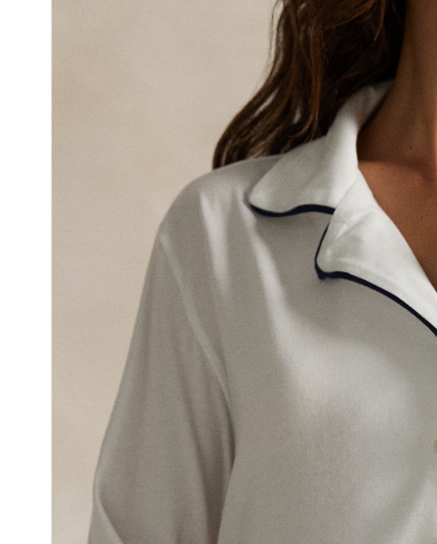 Crafted from a soft cotton blend, this pyjama set comes with a long-sleeved buttoned shirt and full-length trousers. Contrast piped trim and  Ralph Lauren Lauren's signature embroidered Pony complete this classic look.