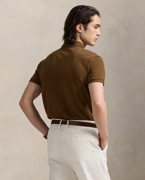 An American style standard since 1972, the Polo shirt has been imitated but never matched. Over the decades, Ralph Lauren Lauren has re-imagined his signature style in a wide array of colours and fits, yet all retain the quality and attention to detail of the iconic original. This trim version is made from our highly breathable cotton mesh, which offers a textured look and a soft feel.