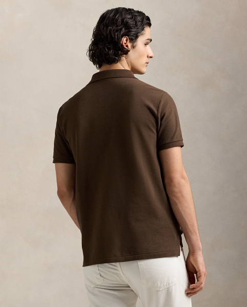 An American style standard since 1972, the Polo shirt has been imitated but never matched. Over the decades, Ralph Lauren Lauren has re-imagined his signature style in a wide array of colours and fits, yet all retain the quality and attention to detail of the iconic original. This trim version is made from our highly breathable cotton mesh, which offers a textured look and a soft feel.