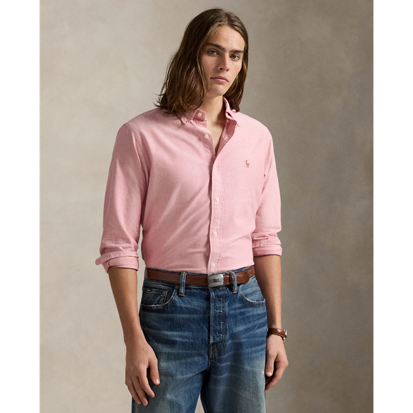 The oxford shirt made its debut very early in  Ralph Lauren Lauren’s designs, and since then, it has solidified its status as a pillar of the Polo look. Our fabric is developed with a secret wash, giving it instant character, ease and a heathered softness – what we refer to as "the perfect rumple". The formula is so unique that it's been kept in a safe for more than three decades. Today, Mr Lauren continues to create countless variations of his iconic shirt, including this Custom Fit version, which is embroidered with our multicoloured signature Pony.