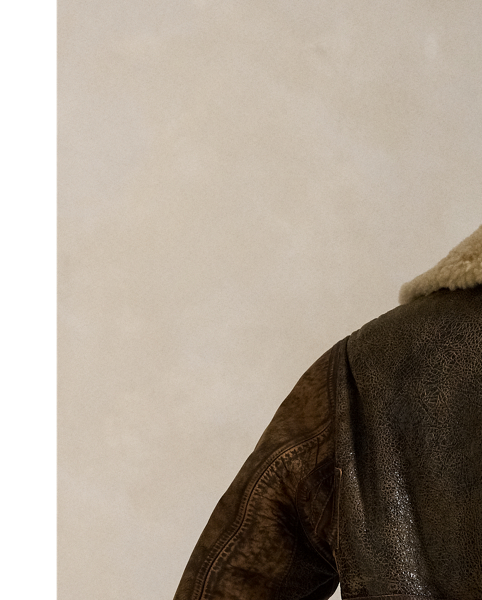 This lightweight bomber jacket is crafted from curly shearling and detailed throughout with full-grain leather piecing.