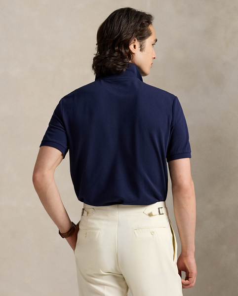 An American style standard since 1972, the Polo shirt has been imitated but never matched. Over the decades, Ralph Lauren Lauren has re-imagined his signature style in a wide array of colours and fits, yet all retain the quality and attention to detail of the iconic original. This version includes a hint of stretch, allowing for unparalleled comfort and ease of movement. It is finished with genuine mother-of-pearl buttons on the placket.