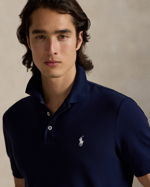 An American style standard since 1972, the Polo shirt has been imitated but never matched. Over the decades, Ralph Lauren Lauren has re-imagined his signature style in a wide array of colours and fits, yet all retain the quality and attention to detail of the iconic original. This version includes a hint of stretch, allowing for unparalleled comfort and ease of movement. It is finished with genuine mother-of-pearl buttons on the placket.