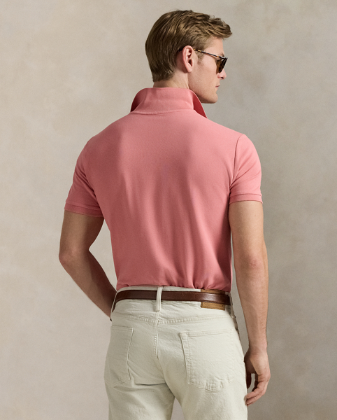 An American style standard since 1972, the Polo shirt has been imitated but never matched. Over the decades, Ralph Lauren Lauren has re-imagined his signature style in a wide array of colours and fits, yet all retain the quality and attention to detail of the iconic original. This version includes a hint of stretch, allowing for unparalleled comfort and ease of movement. It is finished with genuine mother-of-pearl buttons on the placket.